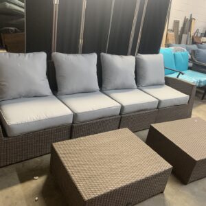 Light brown resin wicker four seater couch with two ottomans. Light grey new cushions.